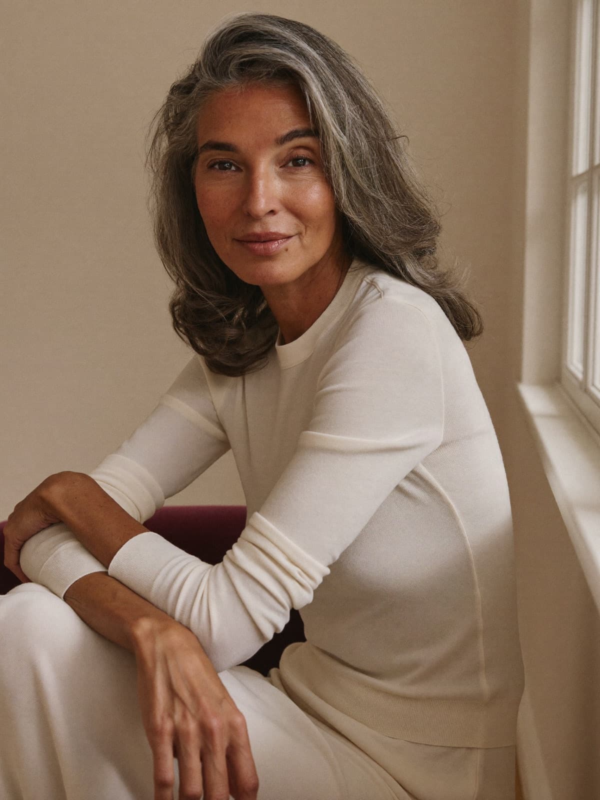 A woman in her fifties at home in soft natural light