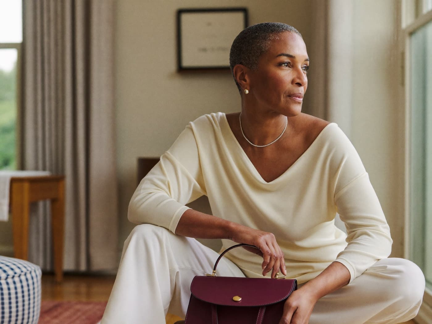 A calm woman in her fifties at home in soft natural light